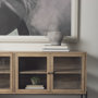 69227 - Arelius 70L x 18.75W x 32H Light Brown Wood, Black Metal Base w/ 4 Glass Cabinet Doors Sideboard